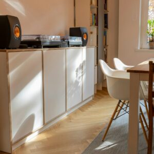 black and silver stereo component on white wooden cabinet